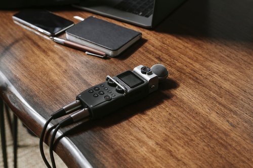 Voice recorder on a wooden table.